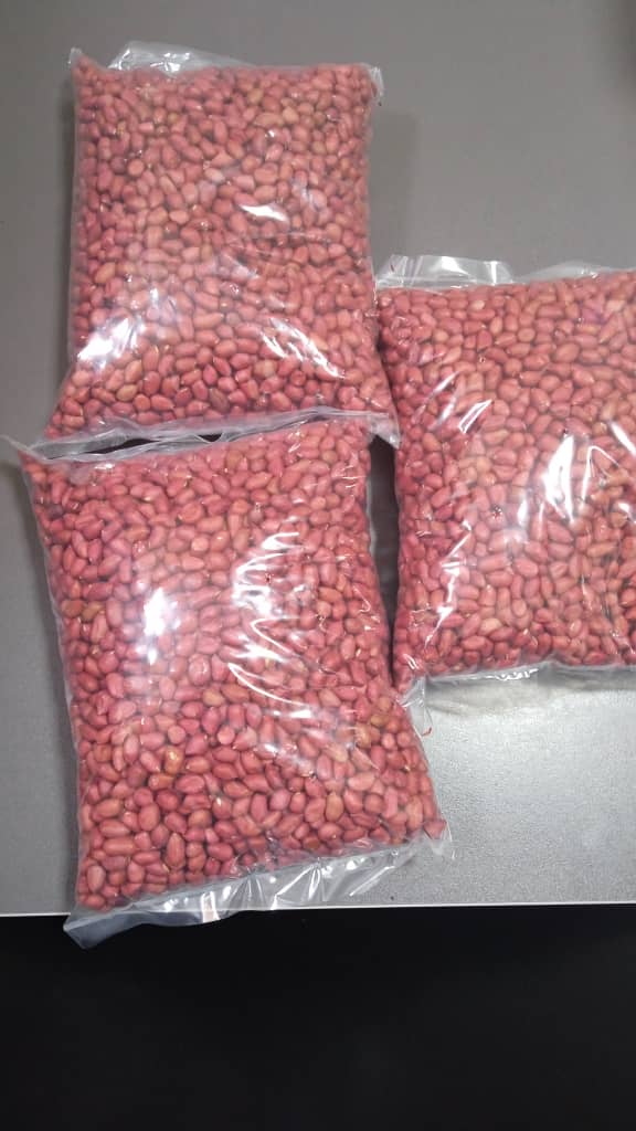 Bags of shelled red groundnuts