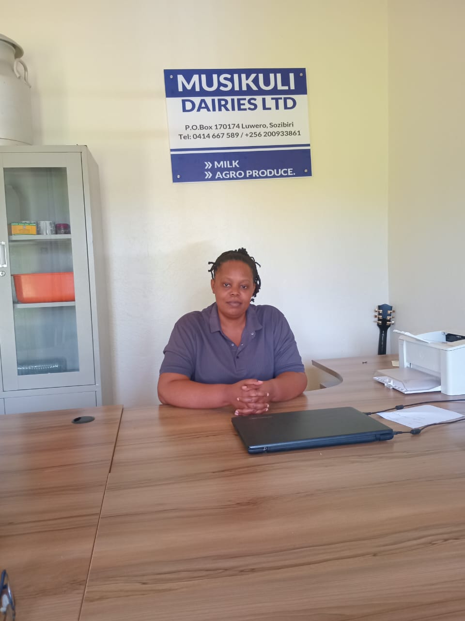 Co-Founder Reginah Nabateregga at office desk